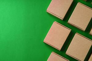 Brown cardboard boxes arranged on a vibrant green surface photo
