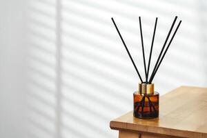 Elegant Reed Diffusers on Wooden Surface With Soft Background Light photo