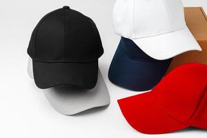 Stack of Assorted Baseball Caps on a White Background photo