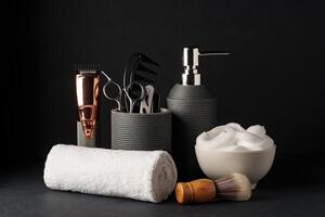 Professional Barber Tools Displayed on Black Background With Towel and Shaving Cream photo