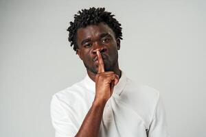 African Man Making a Hush Gesture With Finger photo