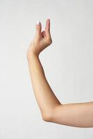 Hand picking something against white background copy space photo