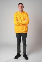 Portrait of a young handsome male in casual clothes on gray background photo