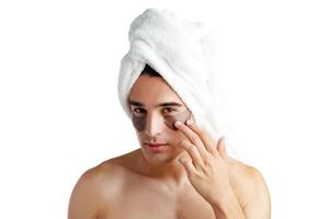 Portrait of attractive young male model with eye patches on white background photo