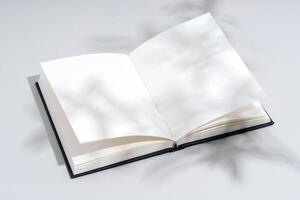 Blank open notepad on gray background studio shot photo