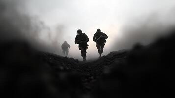 Soldiers advance through a foggy terrain during a military exercise at dawn, demonstrating teamwork and resilience photo