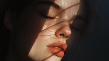 Soft sunlight filters through shadows as a young woman relaxes, capturing a serene moment of quiet reflection indoors photo