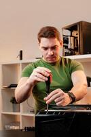 Man assembles a computer system unit at home photo