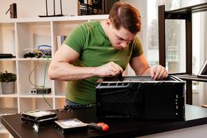 Man assembles a computer system unit at home photo