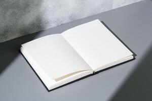 Blank open notepad on gray background studio shot photo
