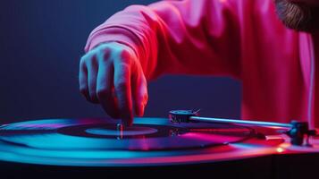 A person spins a vinyl record on a turntable in a dimly lit room with colorful lighting photo