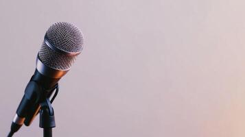 Close-up view of a metallic microphone on a stand, ready for use in a recording studio during an afternoon session photo