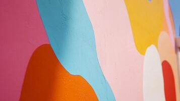 Colorful abstract mural with vibrant shapes and smooth textures in an outdoor urban setting during daylight hours photo