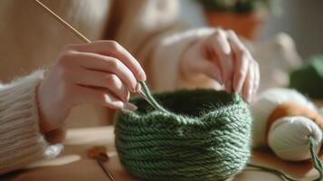 A person skillfully crochets a green basket using yarn in a cozy indoor setting during daylight hours photo