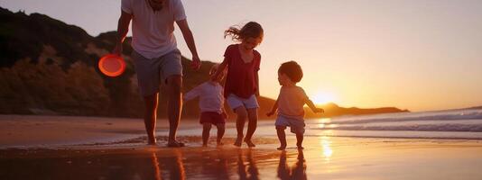 Family enjoying a sunset walk on the beach while playing with a frisbee in the gentle waves during a summer evening photo