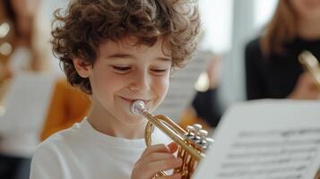 Young musician playing the trumpet with joy during a music class in a bright studio in the afternoon light photo