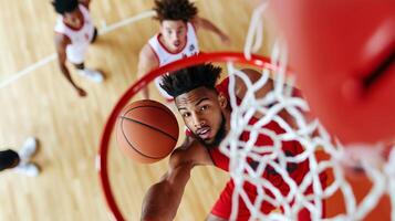 A basketball player attempts a layup while competing with opponents on the court during an intense game photo