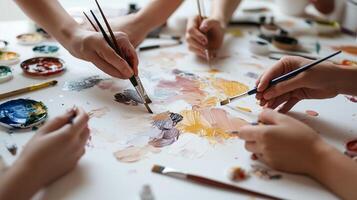 Artistic collaboration in a vibrant studio with hands mixing colors on a palette during a creative group session photo