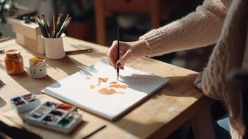A person creates a watercolor painting at a sunlit art studio filled with supplies and vibrant colors in the afternoon photo
