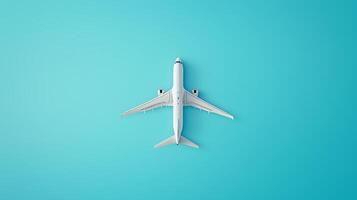 Aerial view of a white airplane flying over a bright blue background during a clear day photo