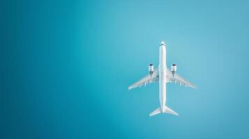 A commercial airplane flying high in a clear blue sky during daytime showing its underside and wings extended photo