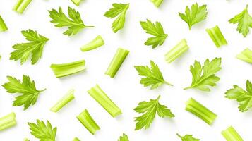 Fresh green celery and parsley leaves arranged artistically on a white background showcasing vibrant textures and colors photo