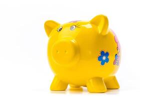 yellow piggy bank isolated on white photo