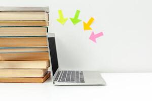 Working desk.Open laptop, books and other office supply photo