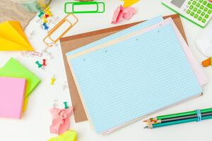 Work place of a creative person with a variety of colorful stationery objects photo