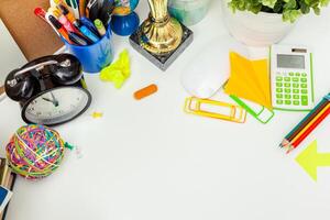 Work place of a creative person with a variety of colorful stationery objects photo