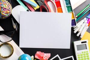 Desk of an artist with lots of stationery objects photo