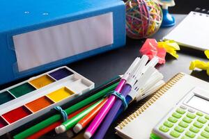 Desk of an artist with lots of stationery objects photo