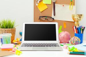 Work place of a creative person with a variety of colorful stationery objects photo