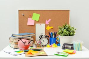 Work place of a creative person with a variety of colorful stationery objects photo