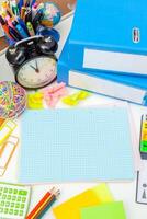 Work place of a creative person with a variety of colorful stationery objects photo