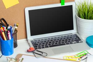 Work place of a creative person with a variety of colorful stationery objects photo