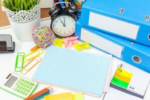Work place of a creative person with a variety of colorful stationery objects photo