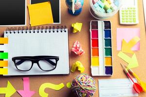Desk of an artist with lots of stationery objects photo