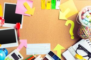 Desk of an artist with lots of stationery objects photo