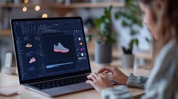 A designer working on a digital sneaker prototype on a laptop in a bright workspace filled with plants and creative tools photo