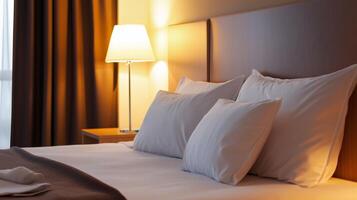 Cozy and inviting hotel room with soft lighting and comfortable bed ready for relaxation in the evening photo