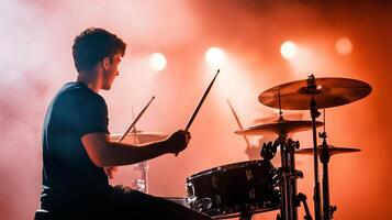 Dynamic drum performance on stage with vibrant lights enhancing the atmosphere during a live concert photo