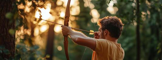 A young man practices archery in a tranquil forest at sunset, focusing intently on his target photo