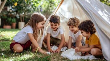 Four children playing joyfully inside a homemade tent in a sunny backyard during a summer afternoon photo