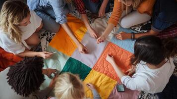 Group of friends engaged in a quilting activity while sitting on the floor, sharing techniques and laughter during a cozy afternoon gathering photo
