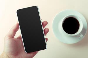 smartphone and coffee on the table photo