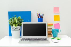 Work place of a creative person with a variety of colorful stationery objects photo
