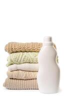 Stack of various sweaters isolated on white background photo