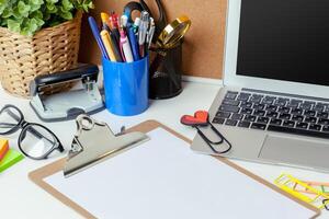Work place of a creative person with a variety of colorful stationery objects photo