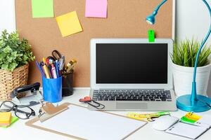 Work place of a creative person with a variety of colorful stationery objects photo